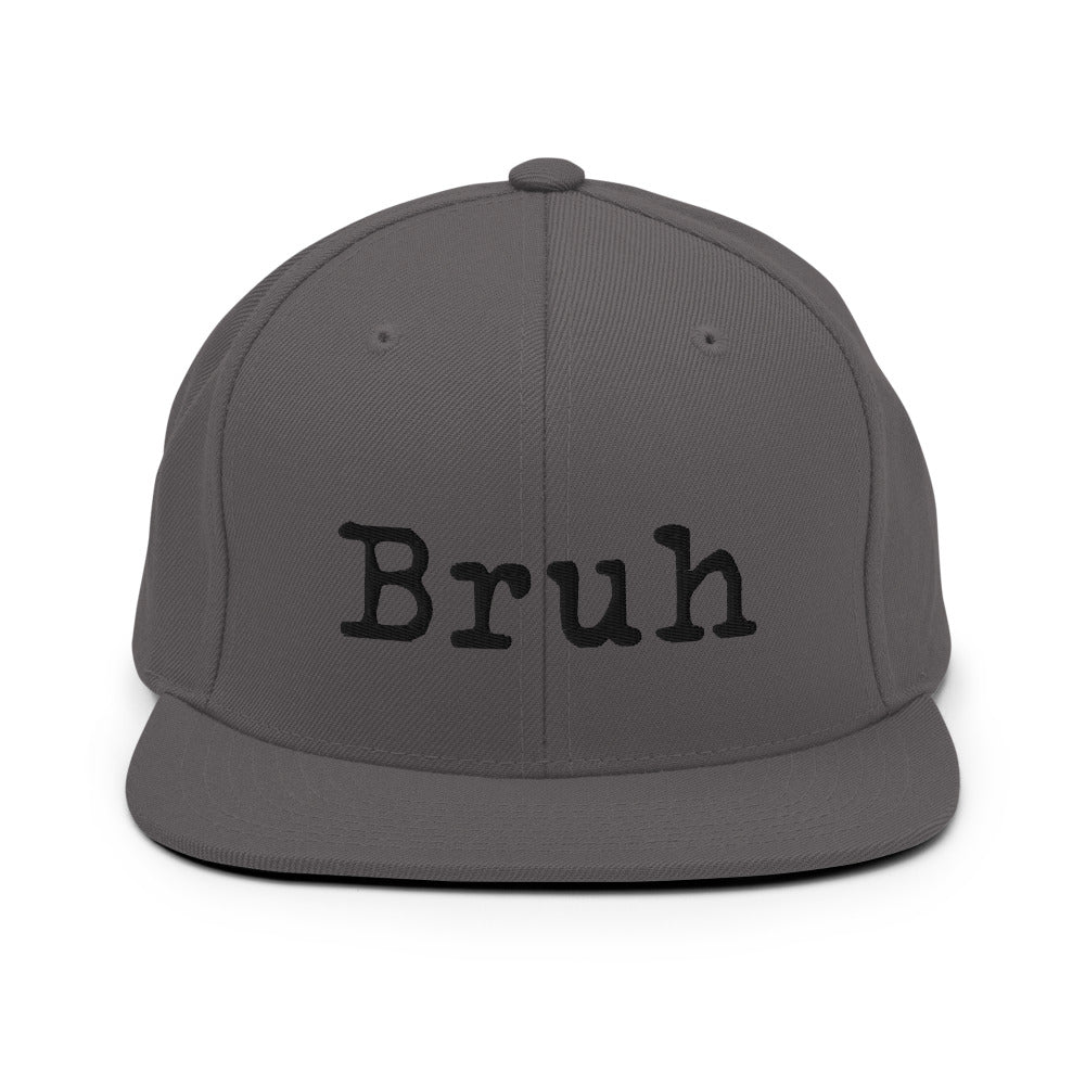 
                  
                    Load image into Gallery viewer, Grey Snapback hat with the word &amp;quot;Bruh&amp;quot; in black typewriter text on the front
                  
                