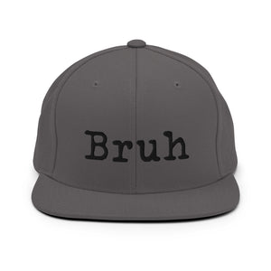 
                  
                    Load image into Gallery viewer, Grey Snapback hat with the word &amp;quot;Bruh&amp;quot; in black typewriter text on the front
                  
                