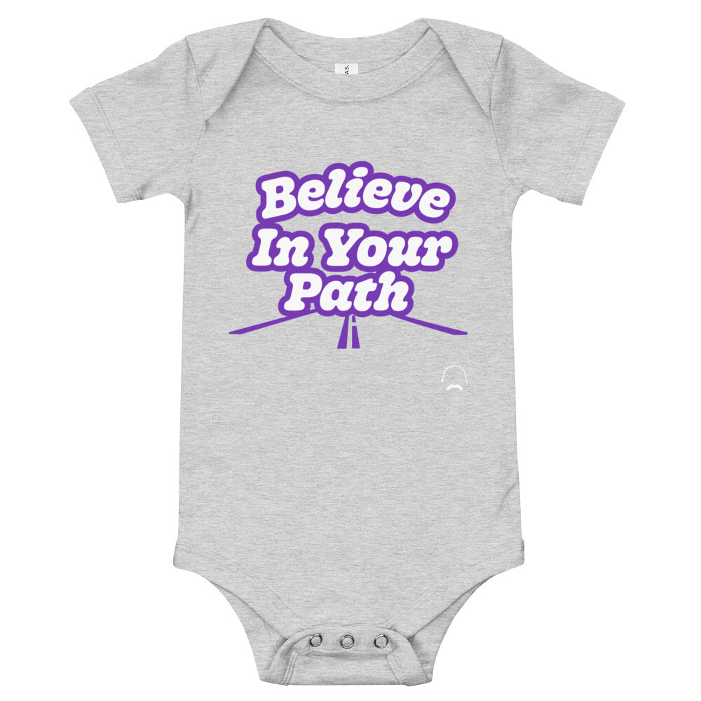 
                  
                    Load image into Gallery viewer, Grey baby onesie with Believe In Your Path text in white with purple outline and a road graphic at the bottom with Steve Harvey Head and Mustache outline in bottom corner
                  
                