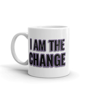 
                  
                    Load image into Gallery viewer, Image of white mug with &amp;quot;I Am The Change&amp;quot; font is black with purple outline and shadowing
                  
                