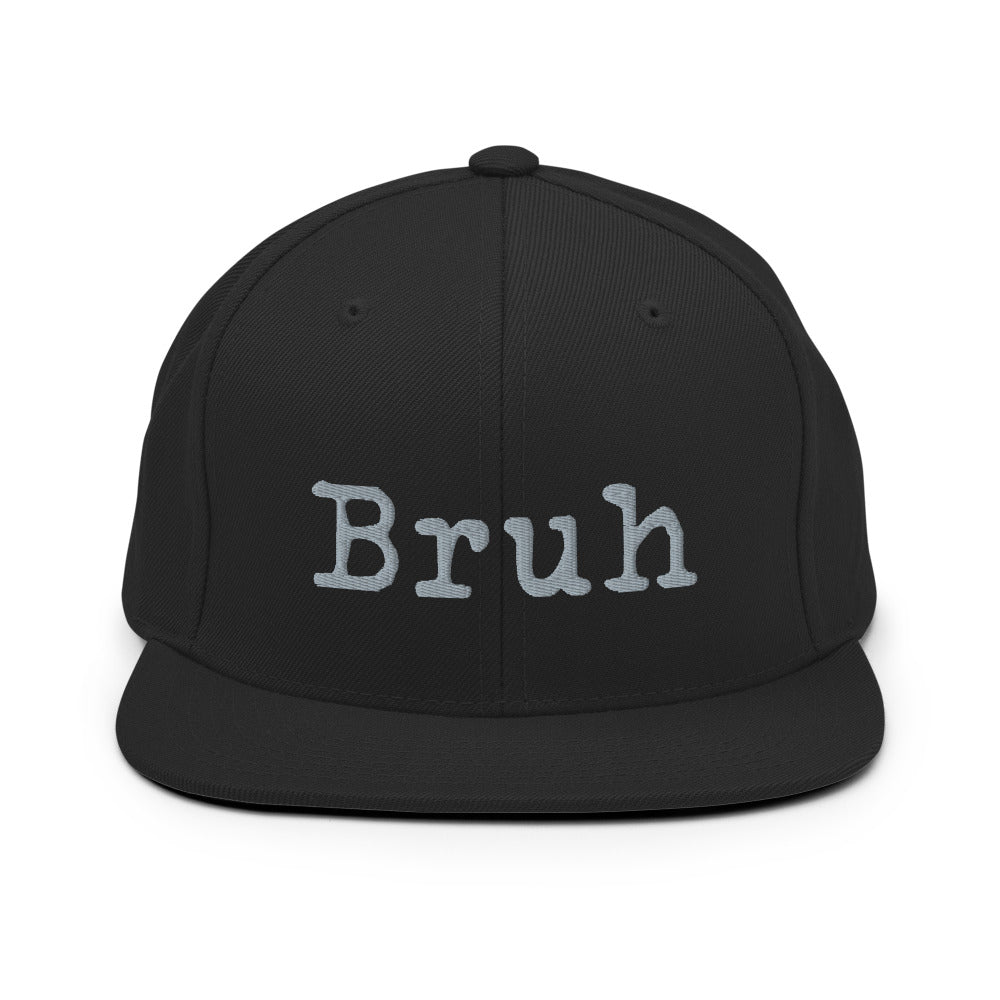 Black Snapback hat with the word "Bruh" in grey typewriter text on the front