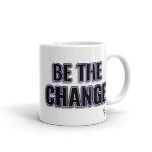 
                  
                    Load image into Gallery viewer, Image of white mug with &amp;quot;I Am The Change&amp;quot; font is black with purple outline and shadowing small Steve Harvey face in the lower right corner
                  
                