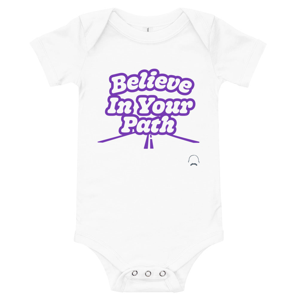 
                  
                    Load image into Gallery viewer, White baby onesie with Believe In Your Path text in white with purple outline and a road graphic at the bottom with Steve Harvey Head and Mustache outline in bottom corner
                  
                