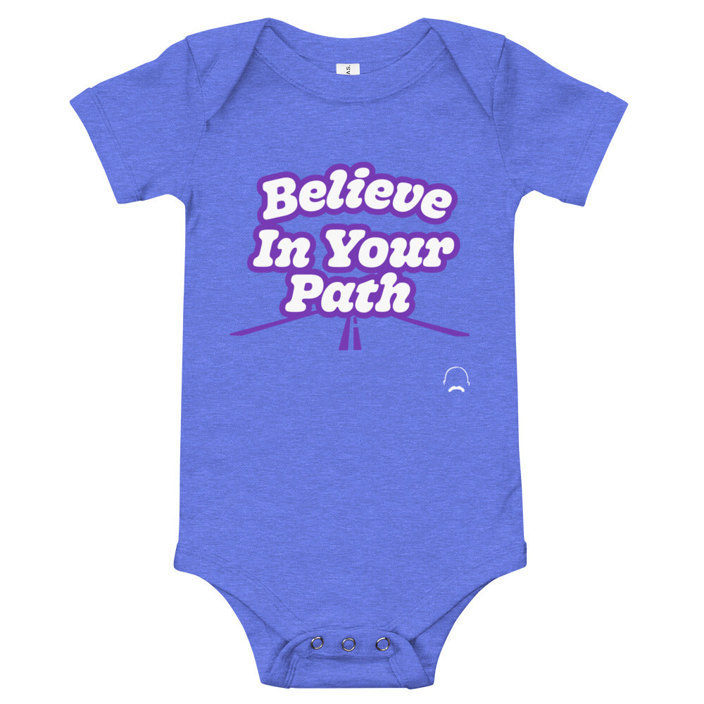 
                  
                    Load image into Gallery viewer, Blue baby onesie with Believe In Your Path text in white with purple outline and a road graphic at the bottom with Steve Harvey Head and Mustache outline in bottom corner
                  
                