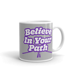 
                  
                    Load image into Gallery viewer, 11 oz White coffee mug with Blieve In Your Path text in white with purple outline and road graphic on grey background
                  
                