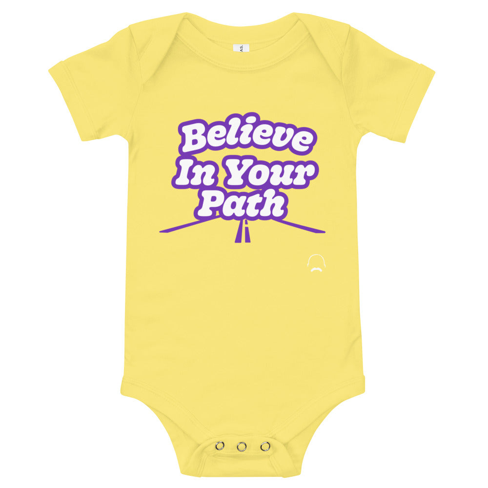 
                  
                    Load image into Gallery viewer, Yellow baby onesie with Believe In Your Path text in white with purple outline and a road graphic at the bottom with Steve Harvey Head and Mustache outline in bottom corner
                  
                