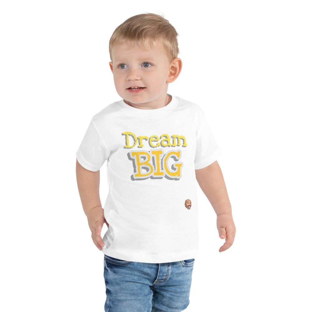 Toddler Modeling White Toddler T-Shirt with The words "Dream Big" in yellow with white outline