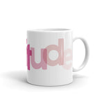 White Mug "Gratitude" every few letters the color is different and a text is horizontally misaligned-side view "tude"